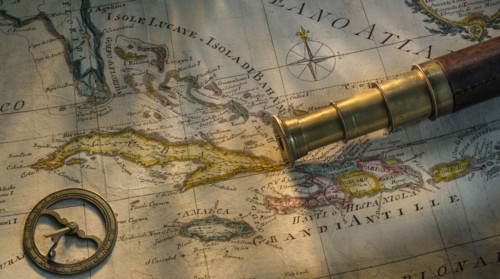 Antique telescope on map
