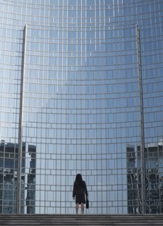 Businesswoman by reflective office building