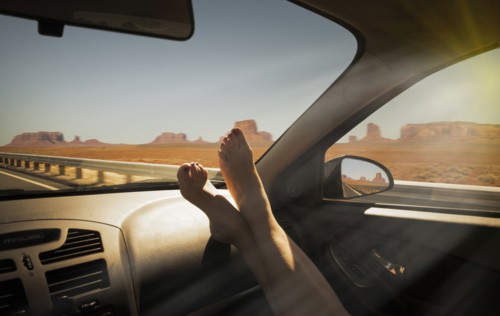 Woman's barefeet on dashboard in Monument Valley Navajo Tribal Park, USA
