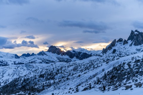 Mountain range in snow at sunset in Dolomites, Italy