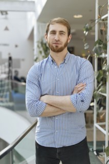 Man wearing striped shirt with his arms crossed