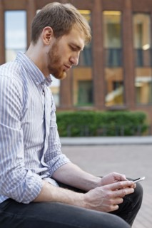 Bearded man using smart phone