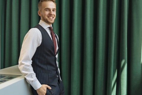 Smiling man wearing pinstripe waistcoat in store