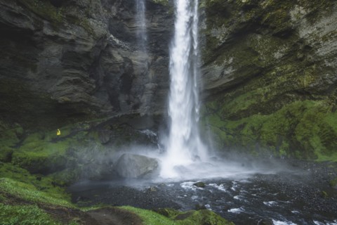 Woman by Kvernufoss waterfall in Iceland