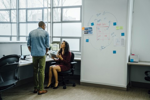 Coworkers talking in office
