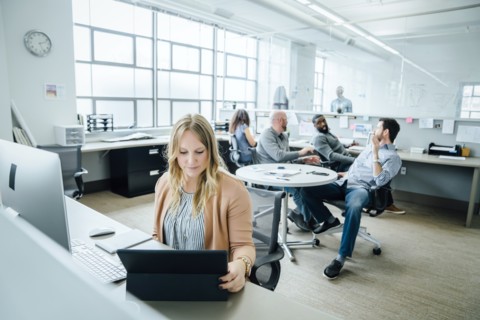 Woman using digital tablet in office