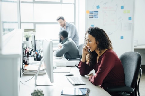 Woman taking phone call in office