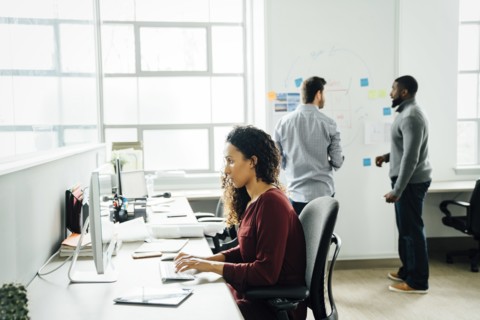 Woman using computer in office