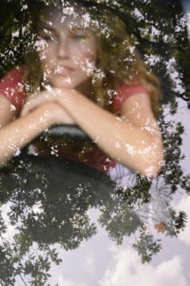 View through windscreen of young woman in car