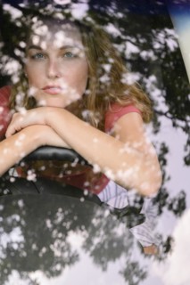 View through windscreen of young woman in car