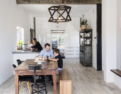Father and son using digital tablet at dining table