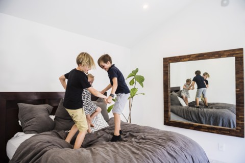 Children jumping on bed