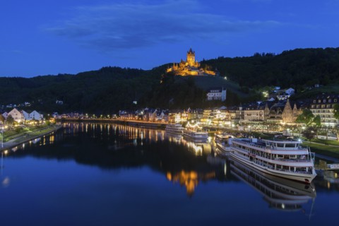 Town and Cochem Imperial Castle by river at sunset in Cochem