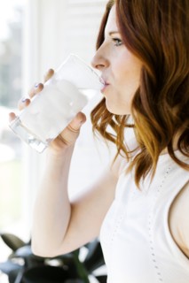 Mid adult woman drinking water