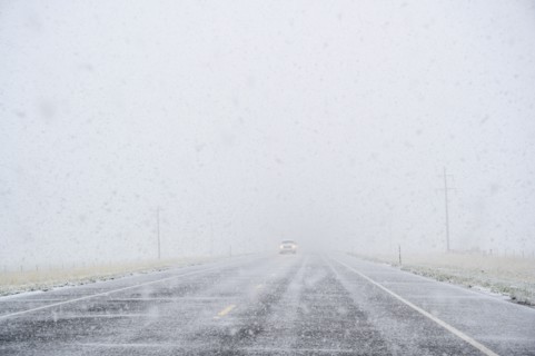 View through windscreen of car on highway during snow