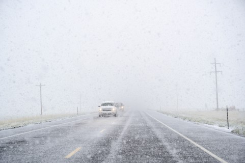 View through windscreen of car on highway during snow