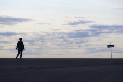 Silhouette of woman walking at sunset