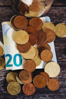 Euro coins on twenty Euro note