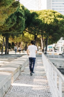 Young man using electric scooter on pavement