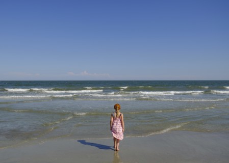 Rear view of girl walking on beach