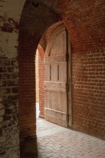 Open door and brick wall