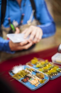 Man by box of tackle and lures