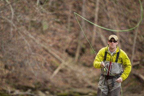 Young man fly-fishing