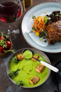 Spinach and salmon soup by grilled meat and salad