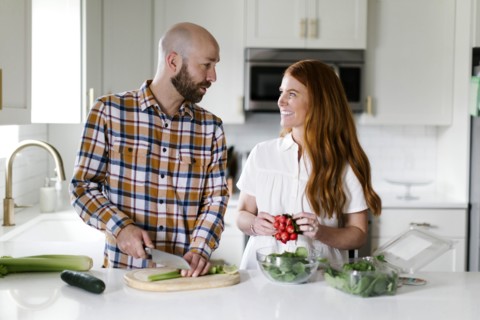 Couple chopping vegetables in kitchen