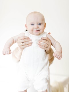 Woman holding out her baby boy
