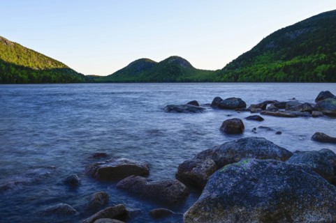 Rocks in Jordan Pond by hills in Acadia National Park, Maine, USA