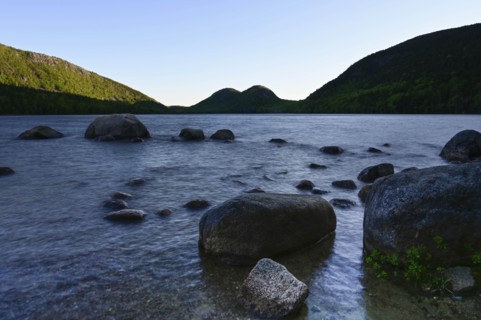 Rocks in Jordan Pond by hills in Acadia National Park, Maine, USA