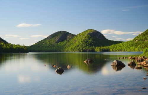 Rocks in Jordan Pond by hills in Acadia National Park, Maine, USA
