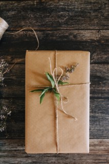 Present wrapped in brown paper with string and flowers