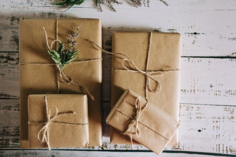 Presents wrapped in brown paper and string with flowers