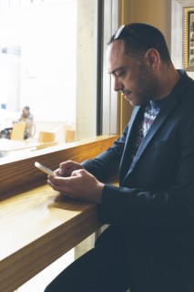 Man using smart phone in cafe