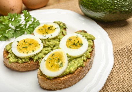 Avocado and egg on toast with parsley