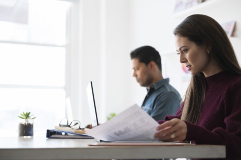 Coworkers working at office desk