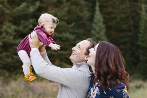 Parents and daughter by forest