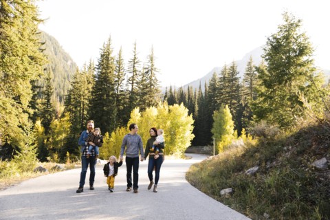 Family and friends on road through forest