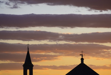 Silhouette of church roof and spire at sunset in Seville, Andalusia, Spain