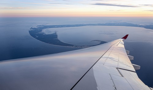 Airplane wing against aerial view of Lower Cape Cod, Massachusetts, USA