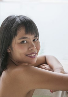 Woman hugging her knees in South Male Atoll, Maldives, South Asia