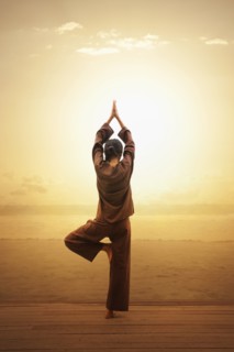 Woman doing yoga by beach in South Male Atoll, Maldives, South Asia