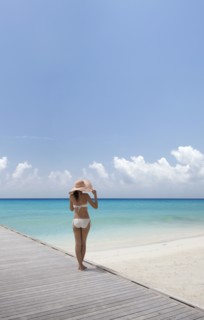 Woman wearing bikini by beach in South Male Atoll, Maldives, South Asia
