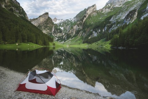 Tent by Seealpsee lake in Appenzell Alps, Switzerland