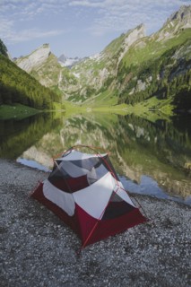 Tent by Seealpsee lake in Appenzell Alps, Switzerland