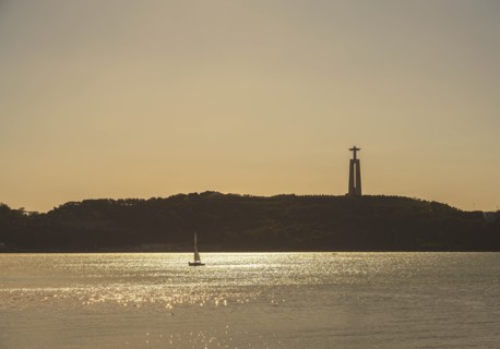 Tagus River with Sanctuary of Christ the King in distance in Lisbon, Portugal