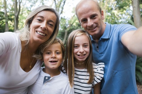 Family taking selfie by trees