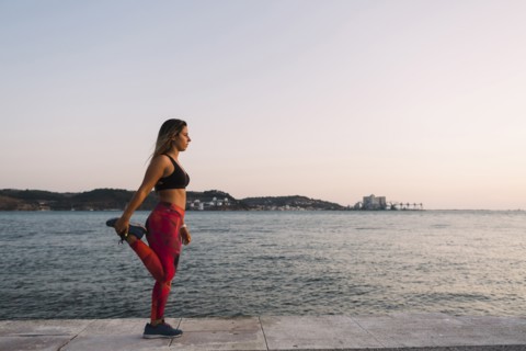 Woman stretching by sea